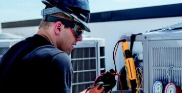 HVAC technician checking the refrigerant on HVAC equipment