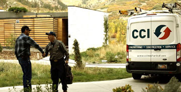 CCI technician shaking the hand of a client with a work truck in the background